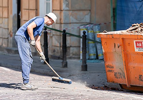 Man Sweeping a Brick Road on Post Construction