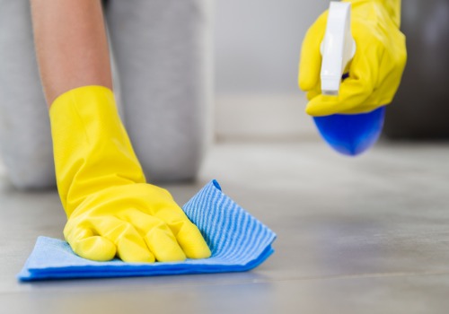 Person scrubs a floor while performing healthcare cleaning in East Peoria IL