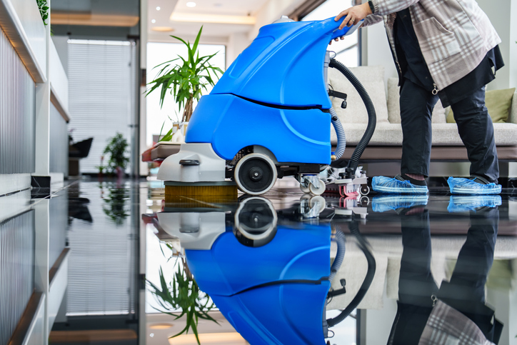 Office Cleaning Company Peoria IL, Worker cleaning office lobby floor with machine
