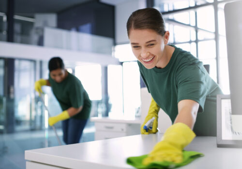 A man and woman provide professional cleaning services for a commercial facility in Urbana IL